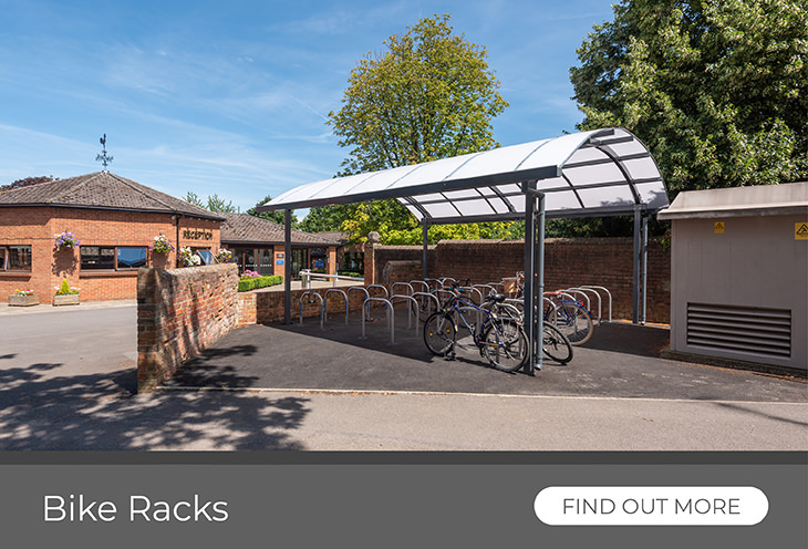 Bike racks under solid roof canopy providing bike parking for school